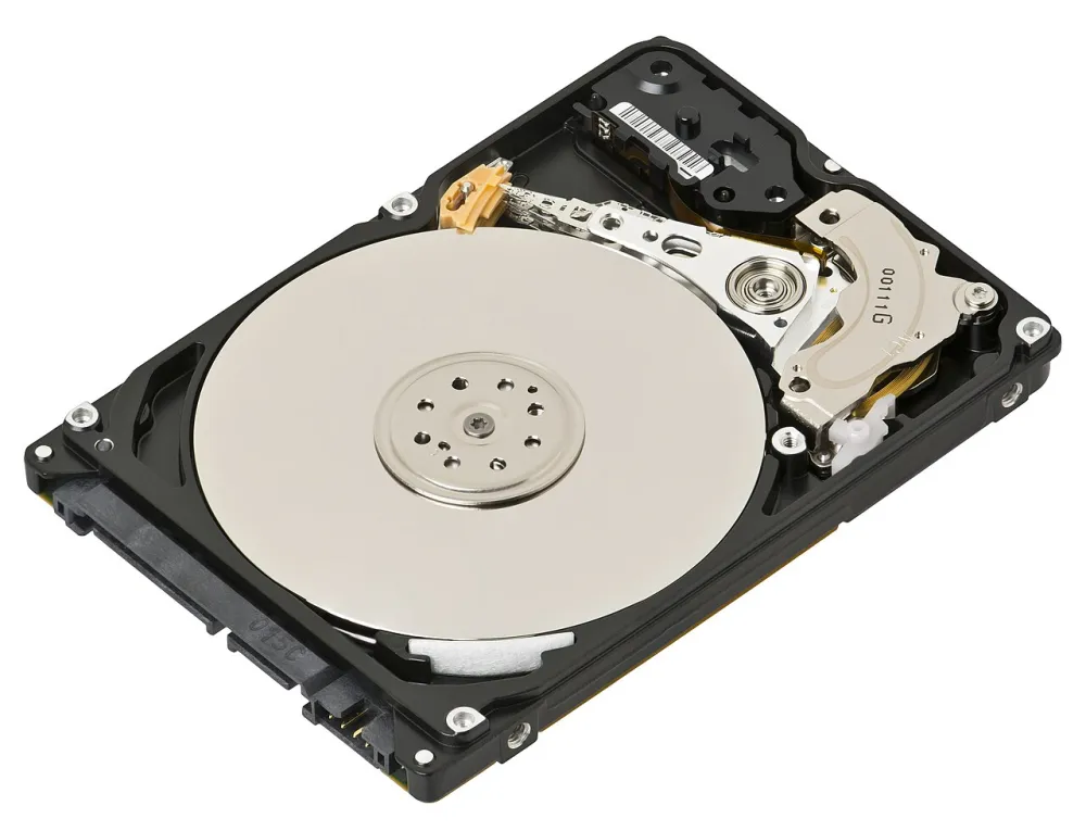 An opened laptop hard disk drive showing a shiny circular platter and the read/write arm lying across it.