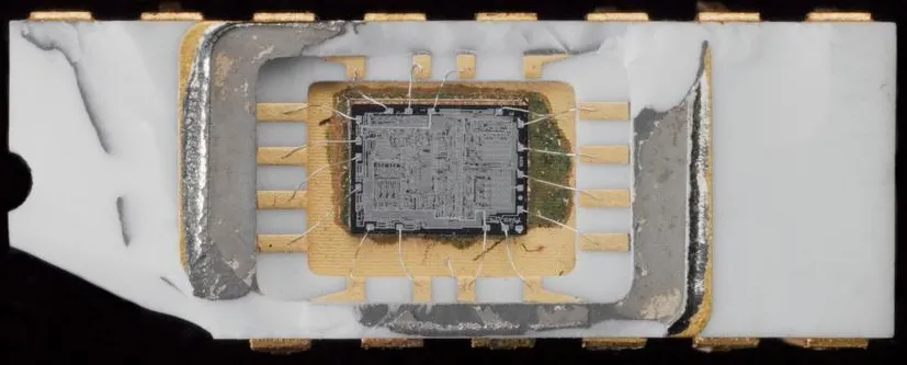 Close-up of the Intel 4004 chip with its package opened, showing the tiny silicon die connected by fine wires.
