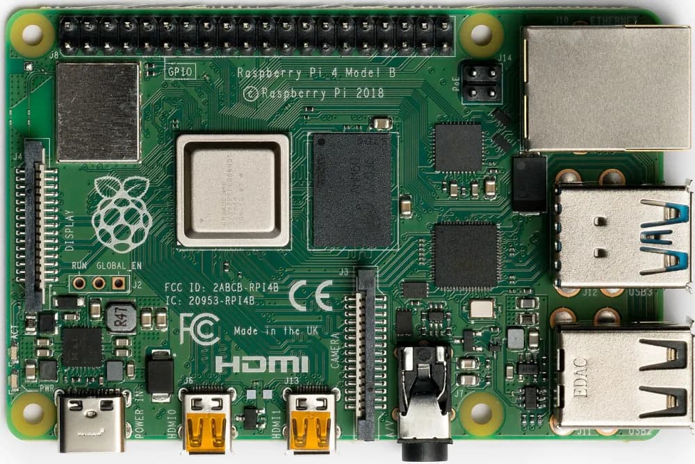 A Raspberry Pi 4 circuit board, about the size of a credit card, with a processor, memory chip and USB and network ports.