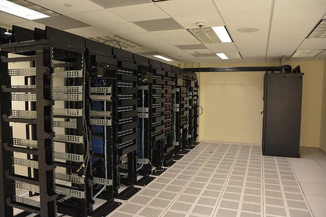 Rows of tall black server racks in a data centre.