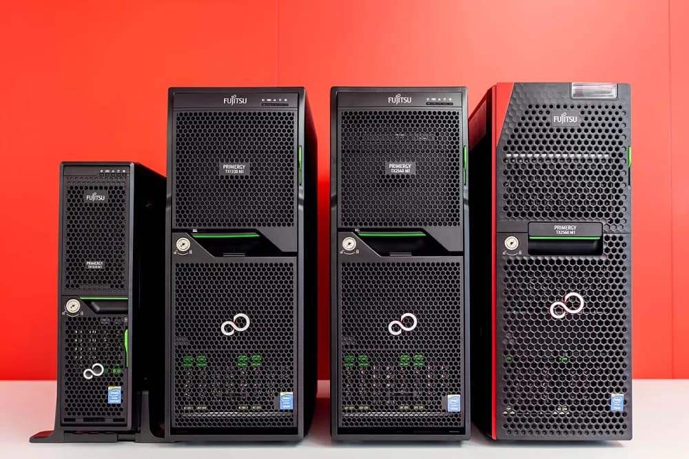Four black tower servers of different sizes standing side by side.